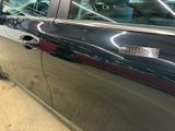 a picture of a car door handle with a sticker on it