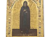 une vieille photo représentant un homme vêtu d'une robe noire tenant une croix