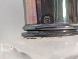 a close up of a bottle of perfume on a table