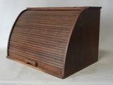 an old wooden roll top desk with a drawer underneath it