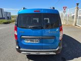 a blue van that is parked on the side of the road
