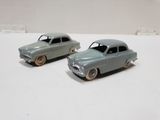 two toy cars that are sitting on a table