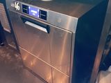 a silver dishwasher sitting in a kitchen next to a trash can