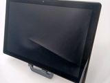 a tablet computer sitting on a stand on a white surface