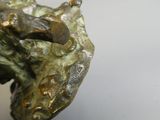 a bronze sculpture of a horse head on a table
