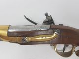a close up of a rifle on a white surface