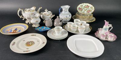 many plates and cups and saucers on the table