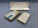 two boxes of cigarettes sitting on top of a table next to a box of cigarettes