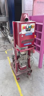 a machine that is sitting on the floor next to a shelf