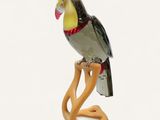 a glass figurine of a bird sitting on a branch