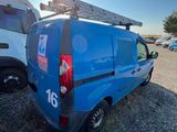 a blue van parked in a parking lot with other vehicles