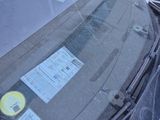 a car that has a parking ticket attached to the windshield