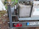 a small machine that is parked on the side of the road