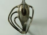 a silver spoon with a metal handle on a white table