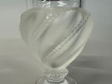 a glass vase with a white liquid inside of it