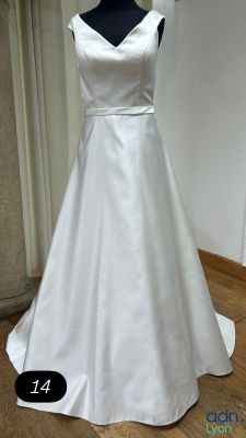 a white dress on a mannequin display in a room