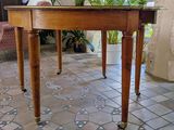 a wooden table with a plant on top of it
