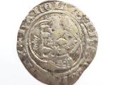 an old silver coin on a white surface with a white background