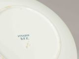 a close up of a white plate with blue writing on it
