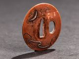 a small copper plate with a design on it