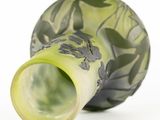 a green vase that has a black and white design on it