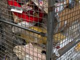 a metal cart with many items in it on the street