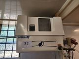 a white microwave sitting on top of a white cabinet