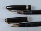 three pens are lined up on a white surface with gold trim