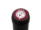 a close up of a bottle of wine on a white surface
