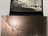 two old photos of a street with buildings and a lamp postcard