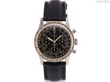 a black and gold watch with a black leather strap