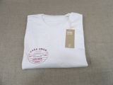 the t - shirt is white and has a brown label on it