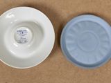 a small bowl and saucer sitting on a table