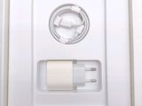 a white box with a charger and a cord attached to it
