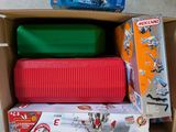 three boxes of toys in a cardboard box on the floor