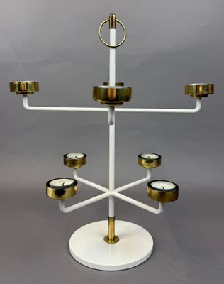 an image of a white and gold candelier with candles on it