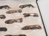 a lot of silver spoons in a case on a table