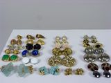 many different types of earrings on a white table