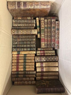 an open box filled with lots of books sitting on top of each other