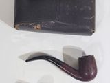 a pipe and a case sitting on a table