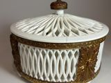 a white and gold box with a lid on a table