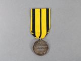 a close up of a medal with a ribbon around it