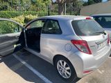 a silver car parked in a parking lot with its door open