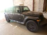 a black jeep that is parked in a garage