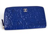 a close up of a blue purse on a white surface