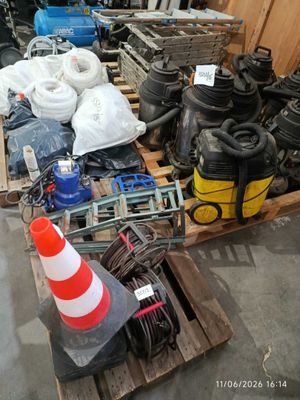 a pile of assorted items on a pallet in a warehouse