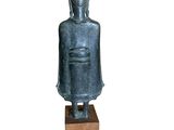 statue of a buddha sitting on a wooden block on a white background