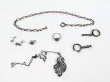 a lot of jewelry that is laying out on the table