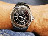 a black watch on the wrist of a person