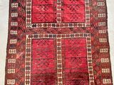 an old rug with a red and brown design on it